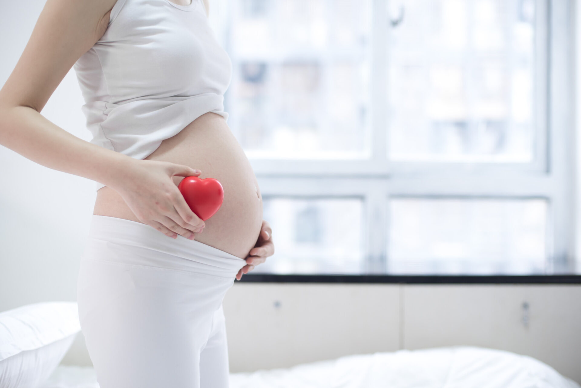 Pregnant Woman Relaxing At Home On The Couch